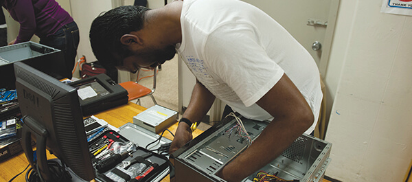 Student testing computer components in a class room